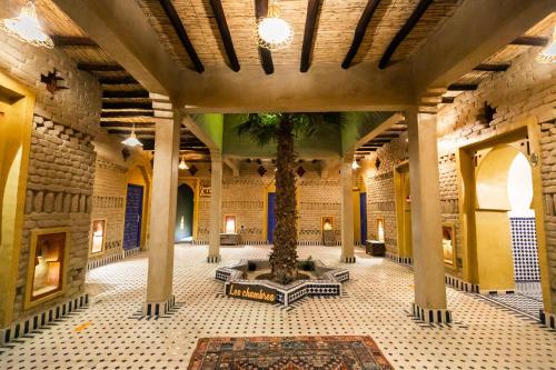 arium of a building with a tree in the middle at Ksar Bicha in Merzouga