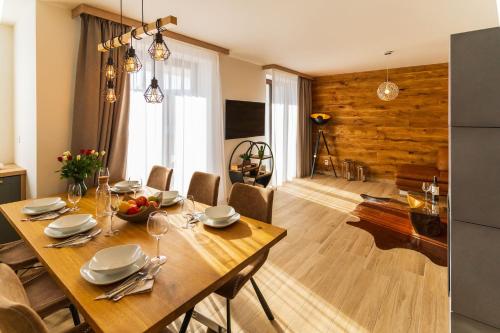 a dining room with a wooden table with chairs and a dining room at Chalets Gardenia in Donovaly