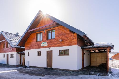 a house with a wooden roof and a garage at Chalets Gardenia in Donovaly