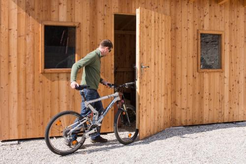 a man with a bike in front of a building at Hotel Stadt Melk in Melk