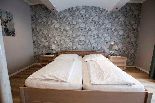 Ένα ή περισσότερα κρεβάτια σε δωμάτιο στο Hotel Garni Landhaus zur Issel