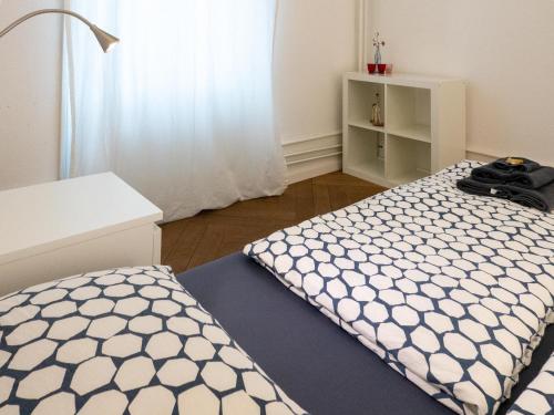 a bedroom with a bed and a white cabinet at Apartments Spalenring 10 in Basel
