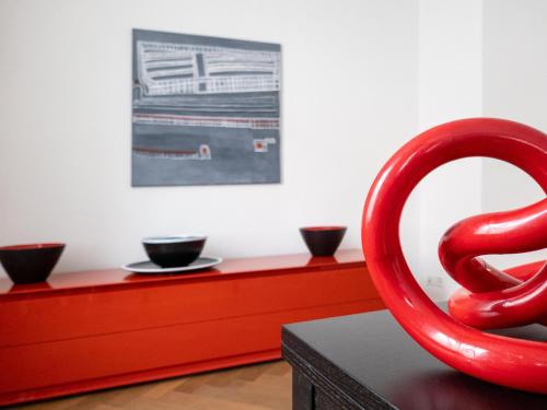 a red sculpture sitting on top of a table at Apartments Spalenring 10 in Basel