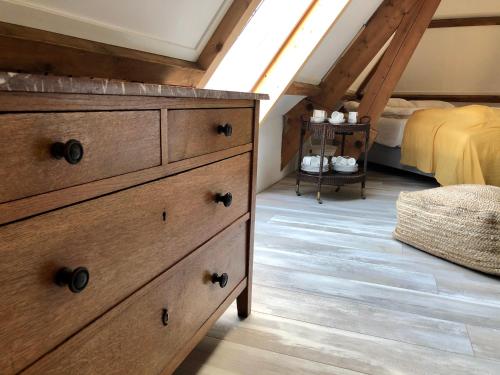 a bedroom with a dresser and a bed at Royale Stadsloft in hartje Middelburg in Middelburg