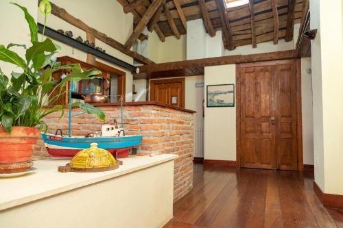 a kitchen with a brick wall and a boat on a counter at La Casona de Hermosa in Hermosa