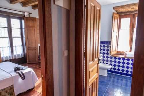a bathroom with a bed and a toilet in a room at La Casona de Hermosa in Hermosa