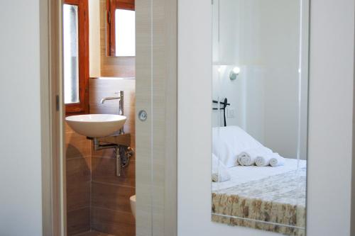a bathroom with a bed and a sink and a sink at B&B D'AMARE in Cupra Marittima