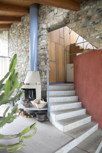 a stone house with a staircase and a fireplace at IseoLakeRental - Villa Dossello in Solto Collina