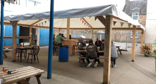 a group of people sitting at tables under a tent at The Aberlour Hotel in Aberlour