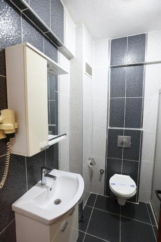 a bathroom with a sink and a toilet at Luna Piena Hotel in Anamur
