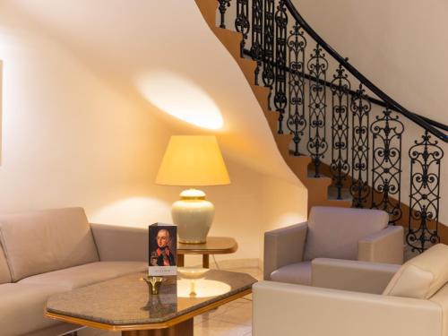 a living room with a couch and a table at Hotel Josefshof am Rathaus in Vienna