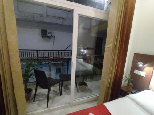 a room with a window with a view of a pool at Hotel The Shivaay - Delight Inn Rishikesh in Rishīkesh