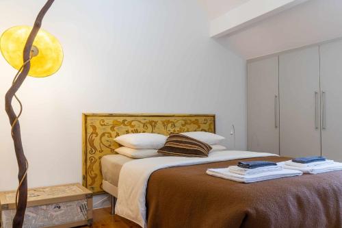 a bedroom with a bed with a gold headboard at CharmingLoft Lisbon Avenida Large and Stylish Apt in Lisbon