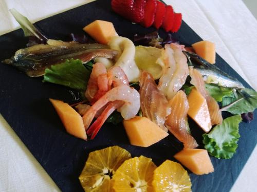 a white plate topped with different types of vegetables at Hotel Villa Esperia in Taormina