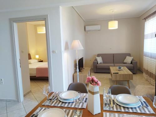 a living room with a dining table and a couch at Blue Yard Apartments in Kalamata