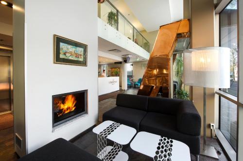 a living room with a couch and a fireplace at Hotel L'Ermitage in Tallinn
