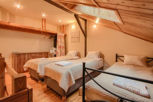 a bedroom with three beds in a room at Marina Lester House in Rydzewo