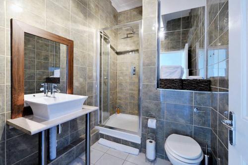 a bathroom with a sink and a toilet and a shower at River View in Bath