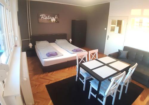 a small room with a table and a bed at Bálint Apartman - In the heart of Miskolc in Miskolc