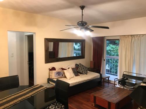 a living room with a couch and a ceiling fan at Mariu Apartment in Buenos Aires