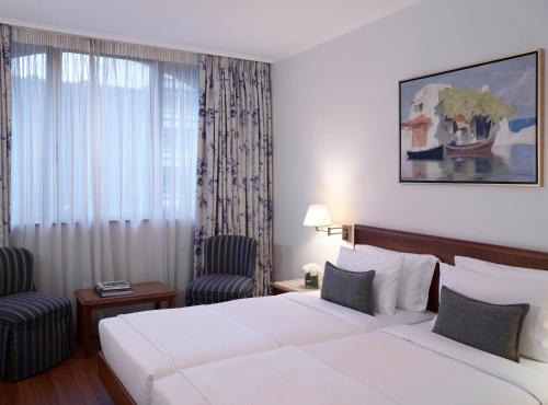 Letto o letti in una camera di Titania Hotel