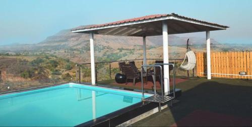 a swimming pool with a gazebo on top of a house at Valley View Igatpuri in Igatpuri