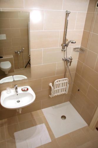 a bathroom with a sink and a shower at Hotel Roma in Cividale del Friuli