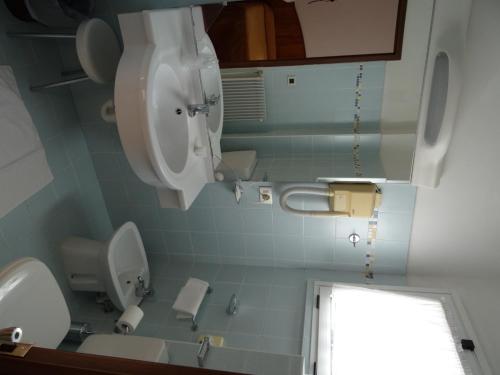 a bathroom with a toilet and a sink at Hotel Roma in Cividale del Friuli