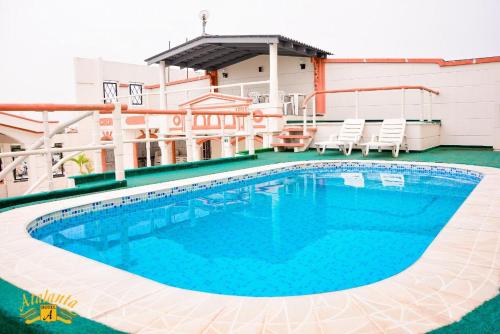 a large swimming pool with chairs on a building at Atalanta Hotel in Macapá