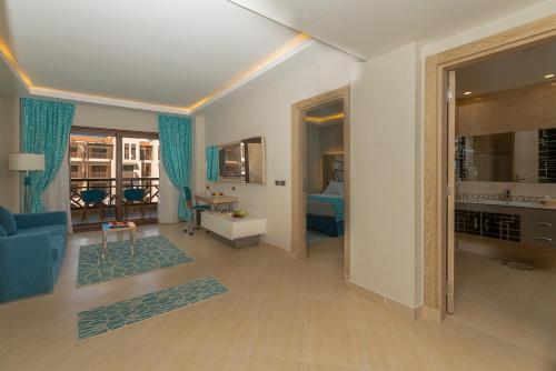 a living room with a blue couch and a living room with at Gravity Hotel & Aqua Park Hurghada Families and Couples Only in Hurghada