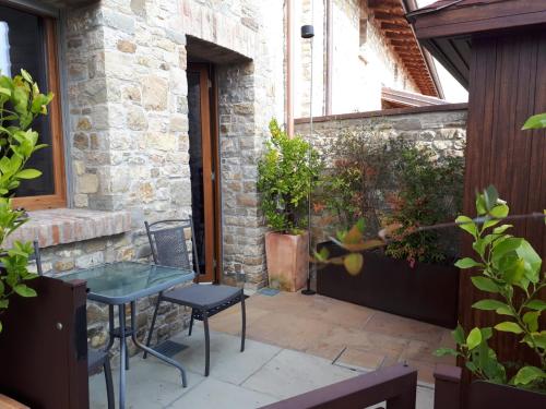 a patio with a table and chairs and plants at Locanda Sensi in Rivergaro