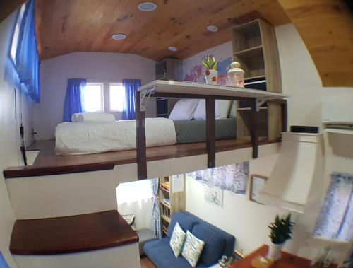 a bedroom with a bunk bed in a house at Tiny House B&B in Kampong Baharu Sungai Udang
