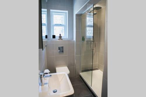 a bathroom with a sink and a shower at The Green House, Harrogate in Harrogate