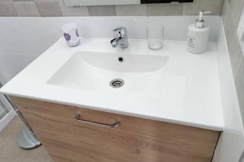 a bathroom sink with a white counter top and a sink at Apartment near the beach in Playa de las Americas