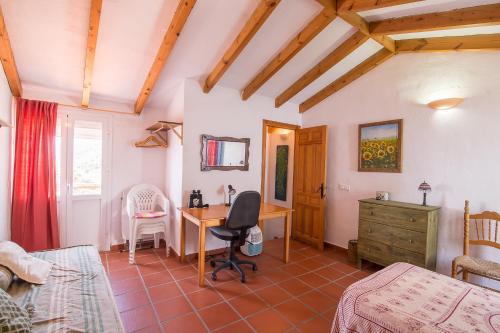 a bedroom with a desk and a bed at La Casita del Arrabal in Casares
