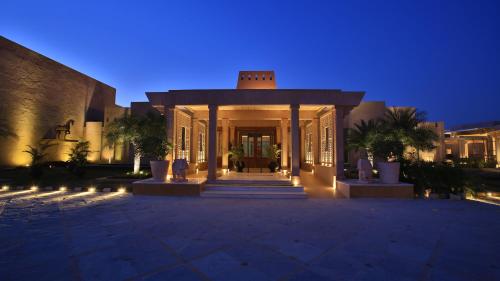 a large building with a lit up entrance at night at Welcomhotel by ITC Hotels, Jodhpur in Jodhpur