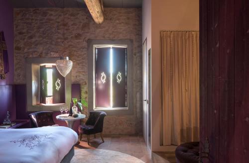 a room with a bed and a table and a window at Village Castigno - Wine Hotel & Resort in Assignan