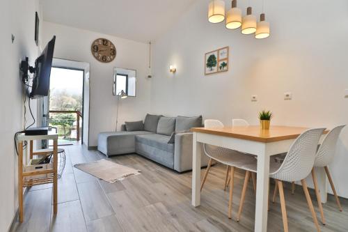 a living room with a table and a couch at Casa do Loureiro 1 - Seia - Serra da Estrela in Seia