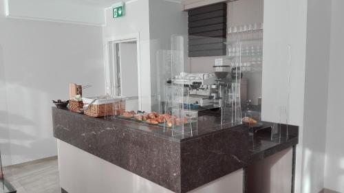 a kitchen with a counter with donuts on it at Novo Hotel Rossi in Verona