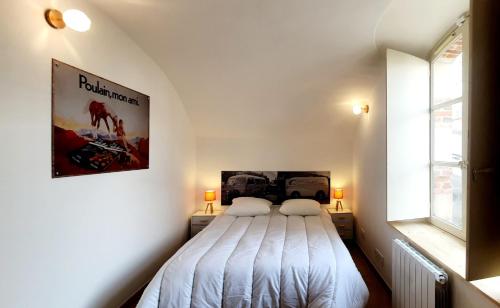 a bedroom with a bed with a poster on the wall at Appartement "La Chocolaterie" en Centre-Ville linge inclus in Blois