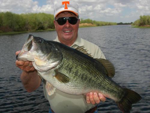 un hombre sosteniendo un pez grande en un lago en Holiday Inn Express Hotel & Suites Palm Bay, an IHG Hotel en Palm Bay