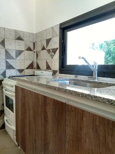 a kitchen with a sink and a window at Casa EBEL in Alpa Corral
