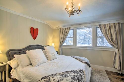 a bedroom with a bed with a red heart on the wall at Modern Farmhouse with Movie Room - 6 Mi to Lake! in Coeur d'Alene
