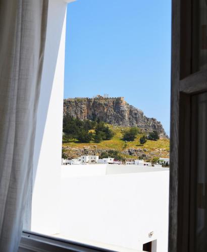 a view of a mountain from a window at Lindian Pearl in Líndos