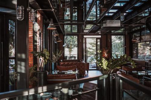 a bar with leather chairs and windows at Letana Hotel in Bang Phli