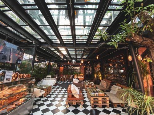 a store with a glass ceiling and a person sitting in a chair at Letana Hotel in Bang Phli