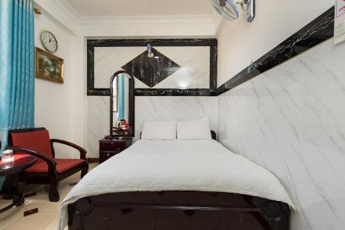 a small bedroom with a bed and a window at Thanh Lan Hotel in Ho Chi Minh City