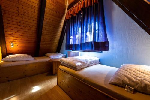 2 Betten in einem Zimmer mit Fenster in der Unterkunft Ferienwohnpark Immenstaad am Bodensee Nurdachhaus Typ 8 NDT 022 in Immenstaad am Bodensee