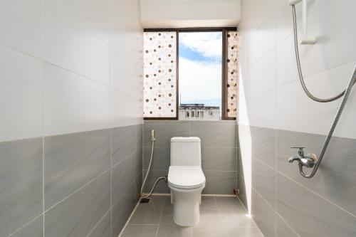 a bathroom with a toilet and a window at Thanh Lan Hotel in Ho Chi Minh City