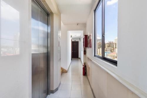 a hallway in a building with a window at Thanh Lan Hotel in Ho Chi Minh City